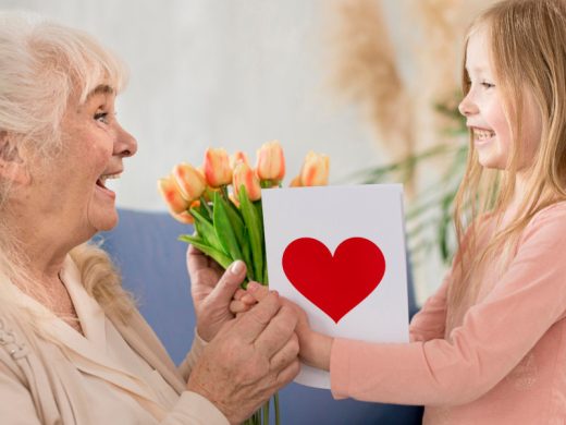 Девочка дарит бабушке тюльпаны